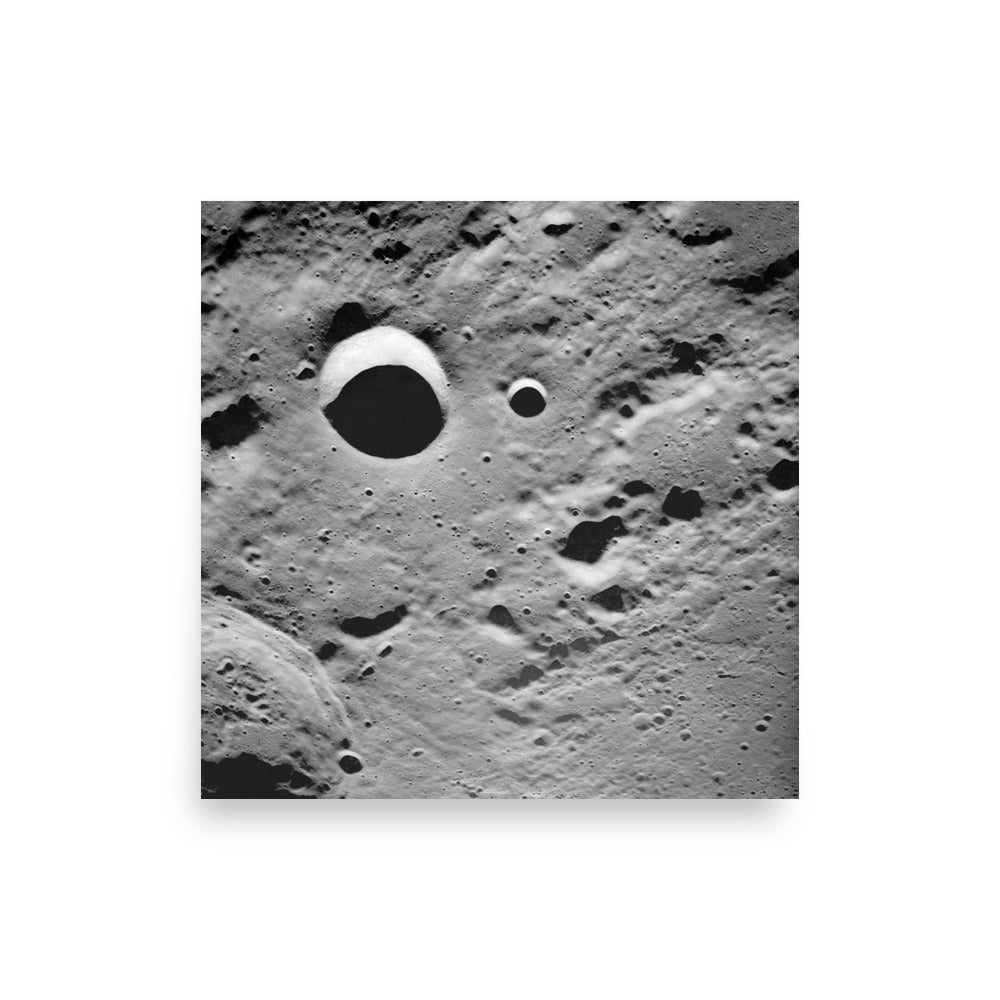 Photograph of the Moon’s surface by NASA, featuring long shadows that highlight the rugged terrain and celestial beauty.